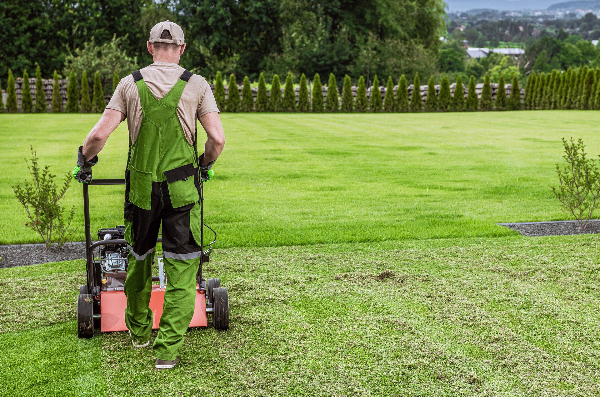 Gardener in His 40s and His Powerful Gasoline Lawn Aerator